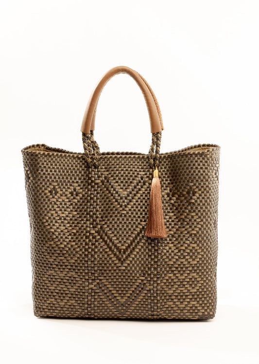 Brown and tan chevron woven bucket bag made from recycled plastics and featuring a tan leather handle and tassel detail