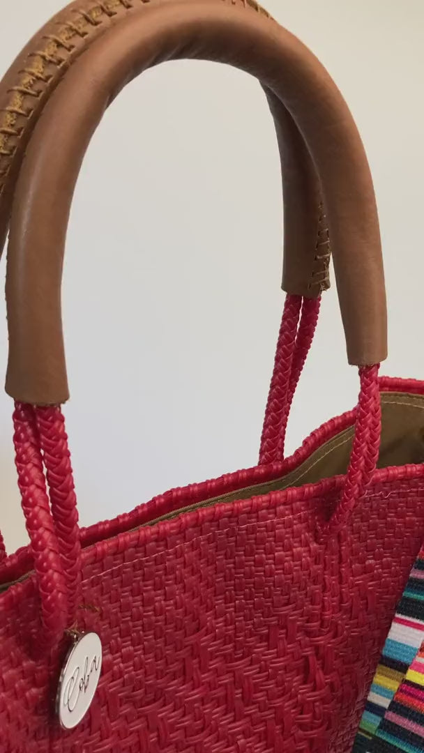 Video of striped purse strap on red tote bag
