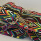 Two multi color purse straps in a row