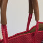 Video of red woven bag with rainbow striped strap