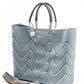 Herringbone pattern purse strap next to blue and white chevron tote bag