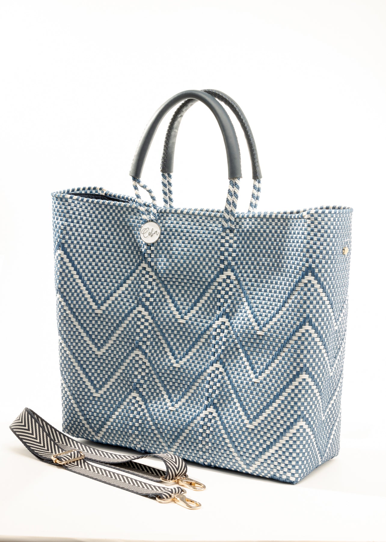 Herringbone pattern purse strap next to blue and white chevron tote bag
