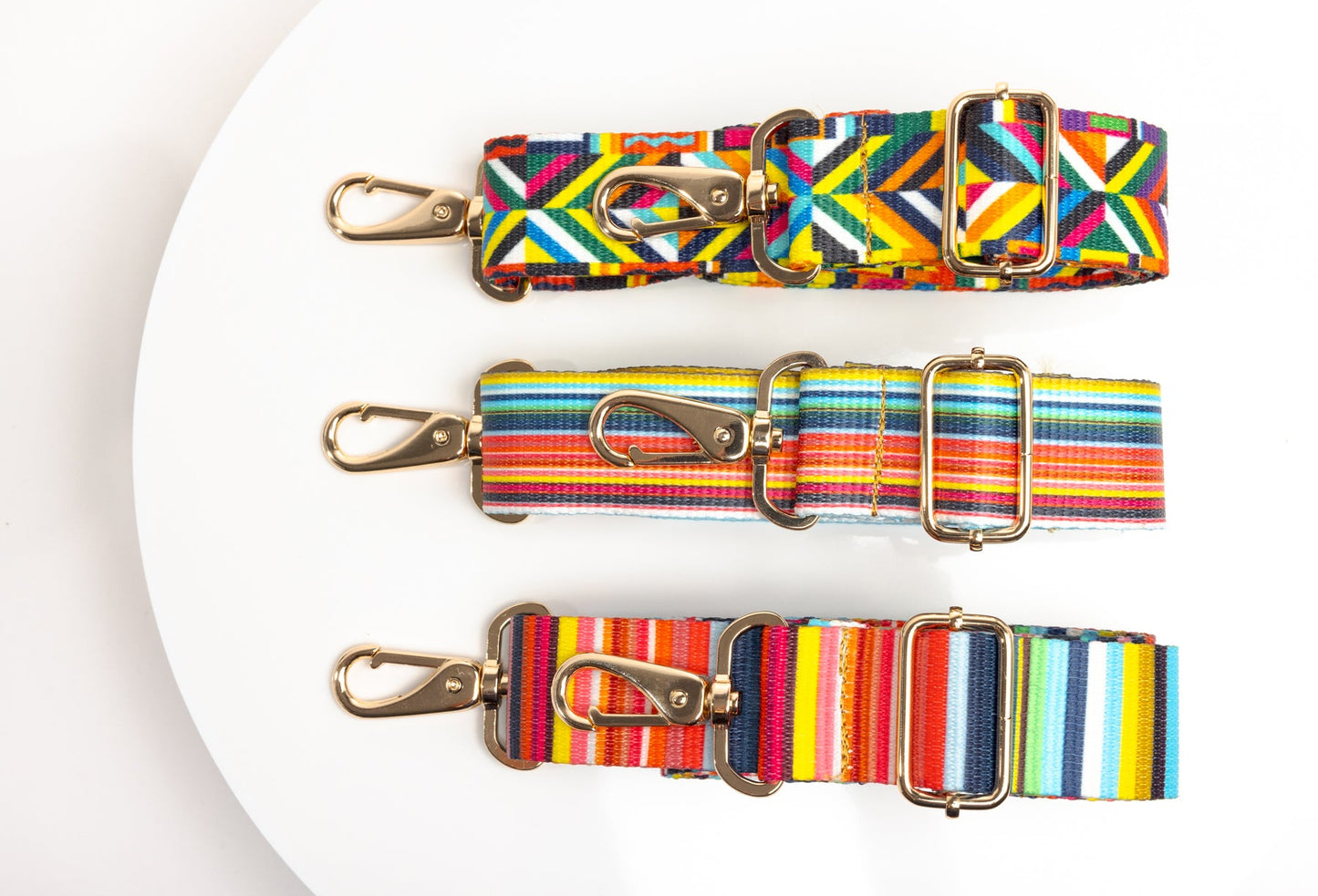 Three colorful bag straps in a row