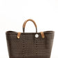 Brown woven recycled bucket handbag with brown leather handles and closure straps and a silver COBA logo medallion