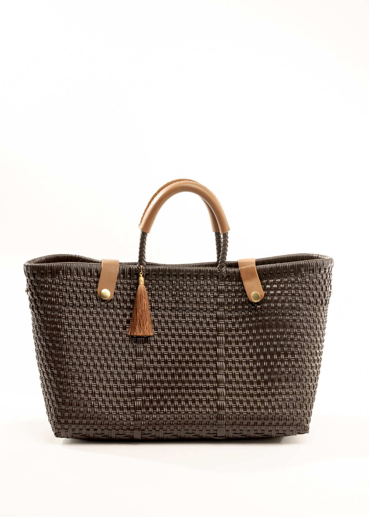 Brown woven recycled bucket handbag with brown leather handles and closure straps and a brown tassel