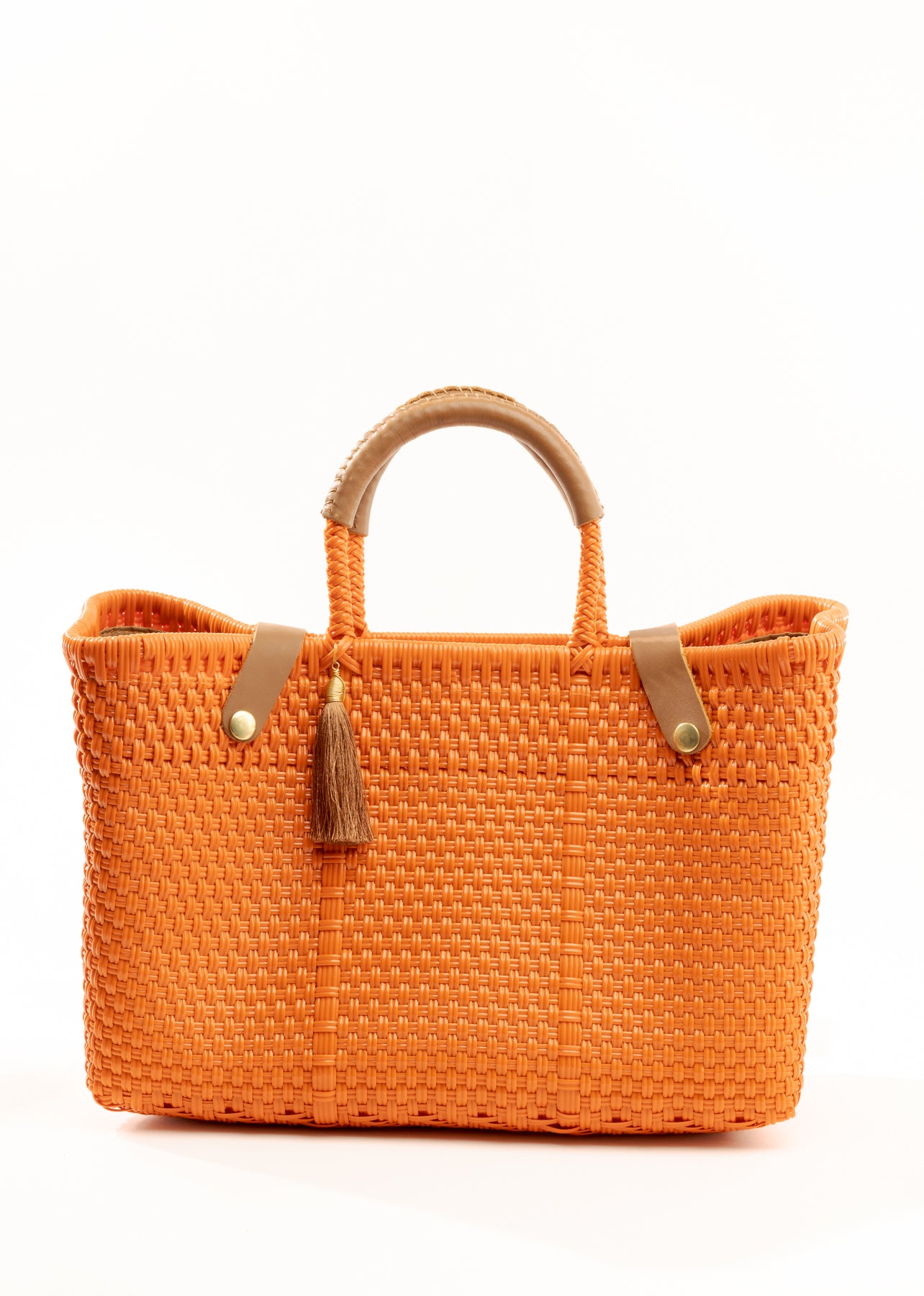 Orange woven handbag with tan leather handle, closure straps, and tassel