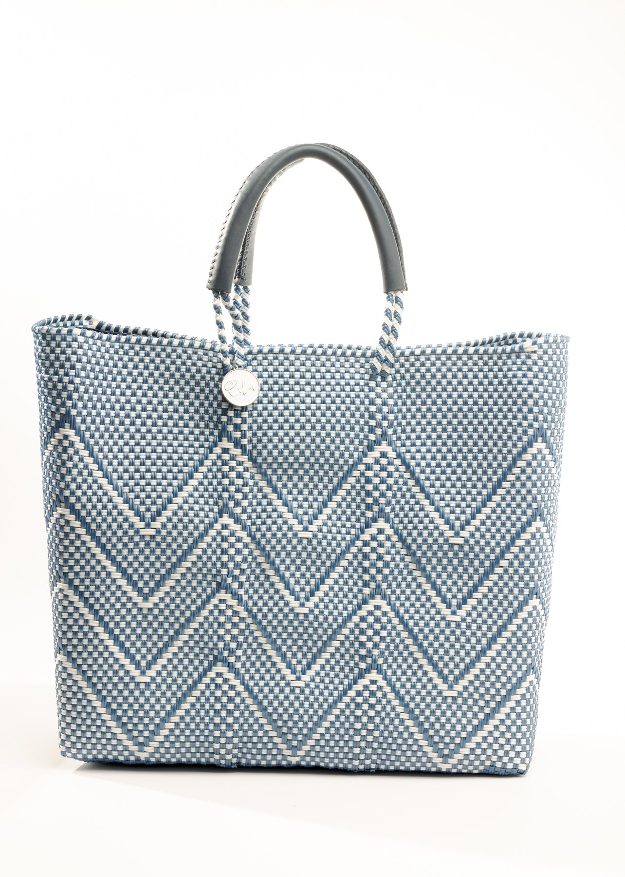 Blue and white chevron tote bag made from recycled plastics featuring a blue handle and silver Coba logo medallion