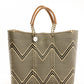 Tan, cream, and brown chevron tote bag made from recycled plastics featuring a tan leather handle and silver Coba medallion detail