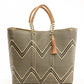Tan, cream, and brown chevron tote bag made from recycled plastics featuring a tan leather handle and tassel detail