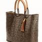 Side angle of brown and tan woven handbag made from recycled plastics featuring tan leather handles and tassel detail