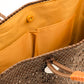 Inside tan lining with two pockets and magnetic closure of brown and tan woven handbag made from recycled plastics