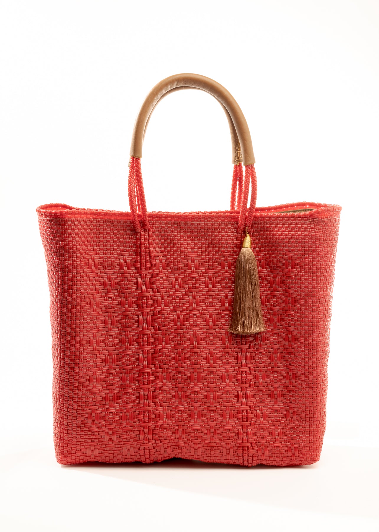 Red woven bucket bag made from recycled plastics with tan leather handle and tassel