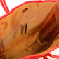 Tan lining with two pockets and magnetic closure of red woven bag made from recycled plastics