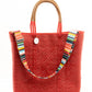 Striped purse strap on red woven tote bag