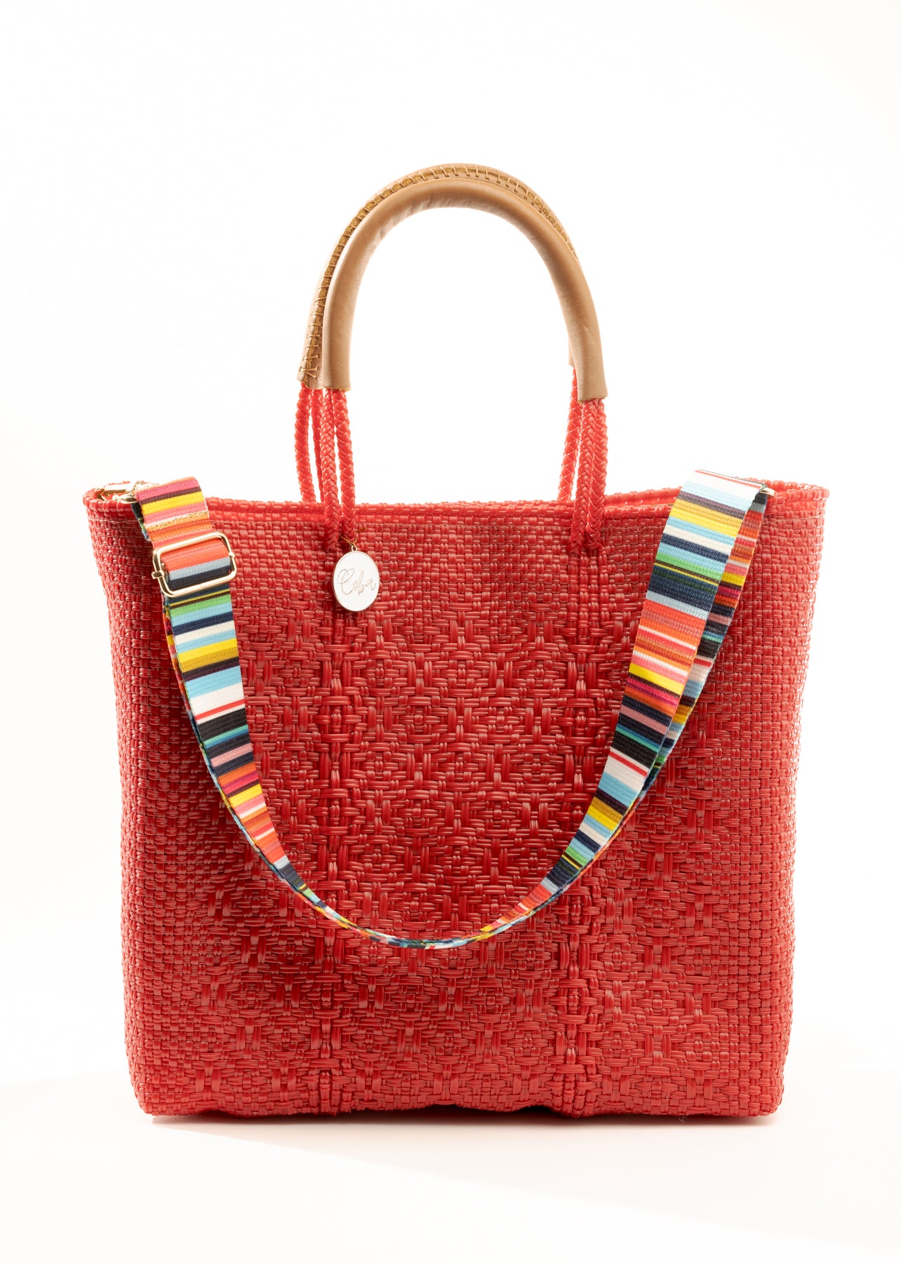 Striped purse strap on red woven tote bag