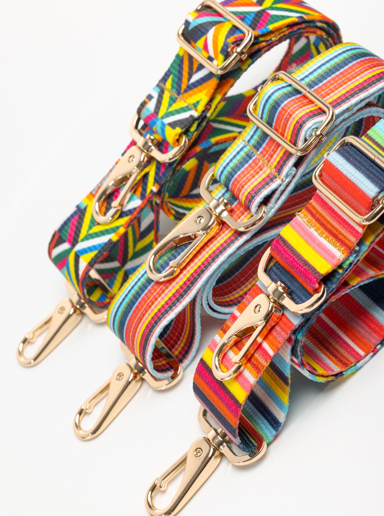 Three multi color purse straps with gold hardware