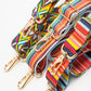 Three multi color purse straps with gold hardware