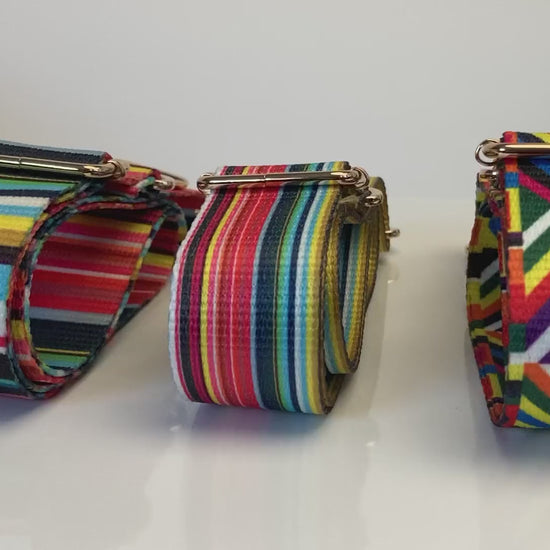 Video of 3 colorful purse straps in a row