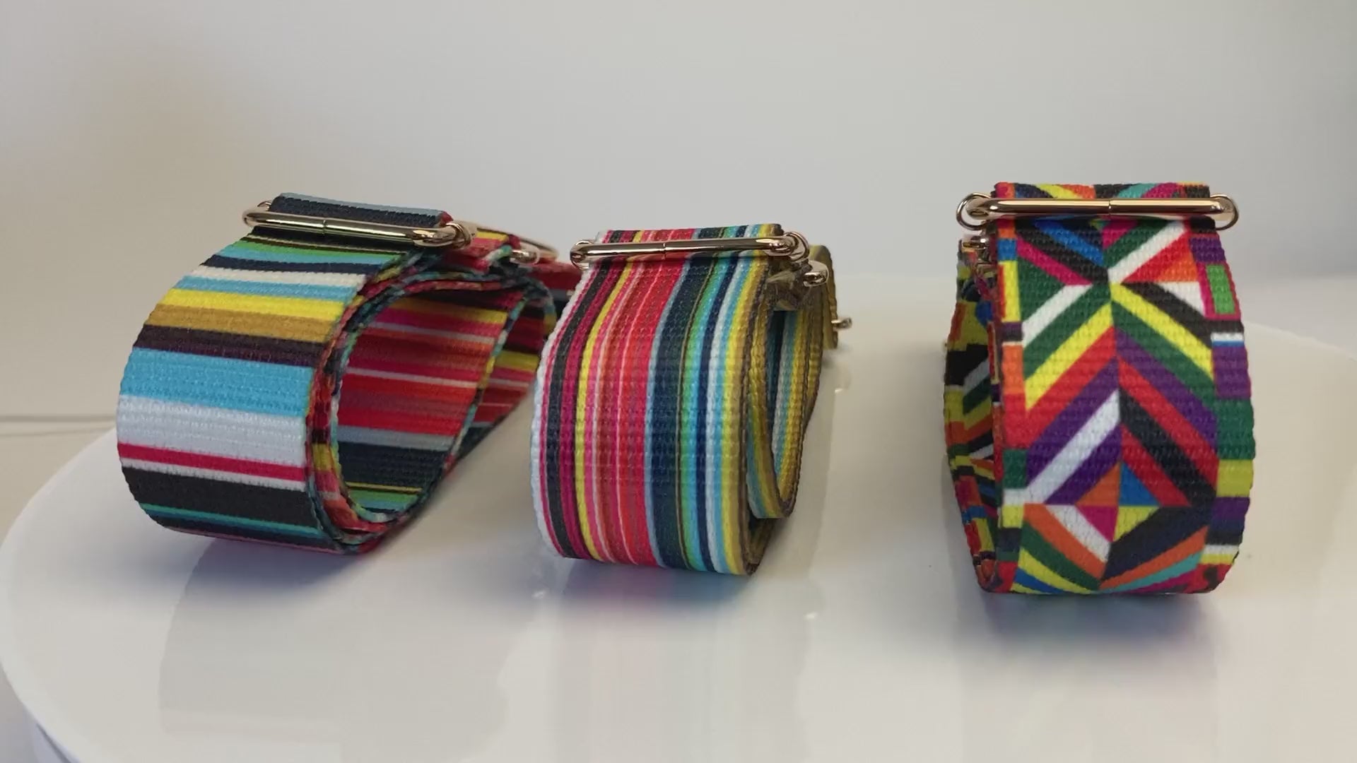 Video of 3 colorful purse straps in a row